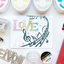 Load image into Gallery viewer, Catherine Pooler - Background Stamp - On Staff. Add some dancing notes to your card background with the On Staff Background Stamp. This red rubber stamp features a winding music staff pattern with notes and musical icons. Available at Embellish Away located in Bowmanville Ontario Canada. Card example by brand ambassador.