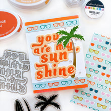 Load image into Gallery viewer, Catherine Pooler - Layered Word Dies - My Sunshine. This word die cuts a frame for the phrase "you are my sunshine" that can be used open or with the letters inlaid back inside for more color contrast. Available at Embellish Away located in Bowmanville Ontario Canada. Example by Catherine Pooler Designs.