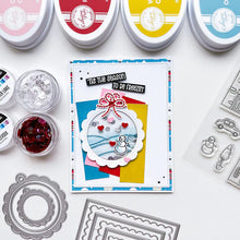 Load image into Gallery viewer, Catherine Pooler - Patterned Paper - Bedford Falls. This paper pack features patterns and prints of life in a sleepy little town. Featuring a print of houses and people out walking their dogs along with post boxes, letters, and snow topped topiaries! Available at Embellish Away located in Bowmanville Ontario Canada. Example by brand ambassador.