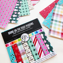 Load image into Gallery viewer, Catherine Pooler - Patterned Paper - Bring on the Figgy Pudding. Add a touch of whimsy to your holiday cards with the Bring on the Figgy Pudding Patterned Paper! This festive collection combines sweet and retro designs with charming patterns and prints. Available at Embellish Away located in Bowmanville Ontario Canada.