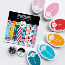 Charger l'image dans la galerie, Catherine Pooler - Patterned Paper - Holiday De-Lights. When trimming the tree, don't forget the holiday de-lights! The Holiday De-Lights Patterned Paper is a quintessential holiday mix of patterns and prints! Available at Embellish Away located in Bowmanville Ontario Canada.