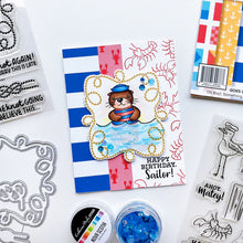 Load image into Gallery viewer, Catherine Pooler - Stamp & Die Set - Ahoy Matey. Get ready for a swashbuckling good time in your crafty space! The Ahoy Matey Stamp Set and its coordinating dies includes a cast of the cutest North East Coast fisherman you have ever seen! Available at Embellish Away located in Bowmanville Ontario Canada. Example by brand ambassador.