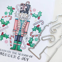 Load image into Gallery viewer, Catherine Pooler - Stamp & Die Set - Nutcracker Sweet. Meet the cutest nutcrackers in town! This whimsical set features charming nutcrackers adorned in a delightful array of sweets and treats, including cupcakes, candy canes, and figgy pudding. Available at Embellish Away located in Bowmanville Ontario Canada.
