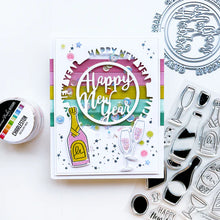 Load image into Gallery viewer, Catherine Pooler - Die - Round of New Year. Add a New Year's greeting with the Round of New Year Dies. This pair of circle word dies can be used together or separately. Layer them with the Circle Dies for festive shaker options. Available at Embellish Away located in Bowmanville Ontario Canada. Example by brand ambassador.