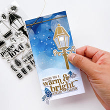 Load image into Gallery viewer, Catherine Pooler - Stamp & Die Set - Warm & Bright. Light glowing works of art, lamps and lanterns are a classic icon of warmth and home. Features these images with candles and greenery to "decorate" them for the winter season. Available at Embellish Away located in Bowmanville Ontario Canada. Example by brand ambassador.