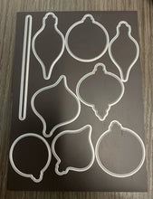 Cargar imagen en el visor de la galería, Gina K. Designs - Stamp & Die Set - Happy Holiday Ornaments. Happy Holiday Ornaments is a stamp and die set by Hannah Drapinski. This set is made of premium clear photopolymer and measures 6" X 8". Made in the USA. Available at Embellish Away located in Bowmanville Ontario Canada.