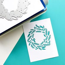 Load image into Gallery viewer, Catherine Pooler - Die - Tree Trimmings. Once you've clipped the tree and made the wreath, you will have a nice collection of Tree Trimmings! This versatile die was created to cut a lovely focal point wreath out of your card layer. Available at Embellish Away located in Bowmanville Ontario Canada. Die cut example.