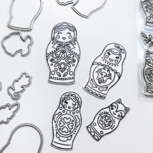 Load image into Gallery viewer, Catherine Pooler - Die Set - We Fit. Remind your friends and loved ones they "just fit" by sending cards made with the We Fit Dies and coordinating We Fit Stamps. Use the dies to cut out one of the three dolls, the cat doll or one of the extras. Layer the pieces to create dimension and fun on all your friendly cards. Available at Embellish Away located in Bowmanville Ontario Canada.