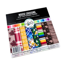 Load image into Gallery viewer, Catherine Pooler - Patterned Paper - Moose Crossing. Oh the beauty of the land and heritage of Canada! The Moose Crossing Patterned Paper celebrates this with patterns including moose, mountains, inuksuks, bears, woodgrain and maple leaves. Available at Embellish Away located in Bowmanville Ontario Canada.
