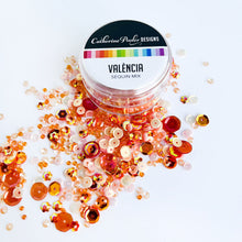 Load image into Gallery viewer, Catherine Pooler - Sequin Mix - Valencia. Add some sparkle in shades of orange with the Valéncia Sequin Mix! This mix was named for Valéncia, Spain and is bright and cheerful. This monochromatic mix and looks great with our Potted Patterned Paper! Approximately 1 Tablespoon mixture packaged in a clear screw top round container. Available at Embellish Away located in Bowmanville Ontario Canada.