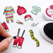 Load image into Gallery viewer, Catherine Pooler - Stamp Set - Old Saint Nick. The Old Saint Nick 6x8 Stamp Set has everything but the man himself! This fun line-art set includes all of Saint Nick's gear from his suit and boots to his long johns to keep him cozy in the North Pole! Available at Embellish Away located in Bowmanville Ontario Canada. Die cut coloured pieces example.