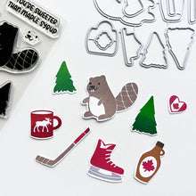 Load image into Gallery viewer, Catherine Pooler - Stamp & Die Set - O Canada. This one is sweeter than maple syrup, eh? Here's too the beautiful country of Canada! This fun icons stamp & die set and it's has images of maple syrup, hockey, a Mountie hat and a hot cup of "Timmies" Available at Embellish Away located in Bowmanville Ontario Canada.