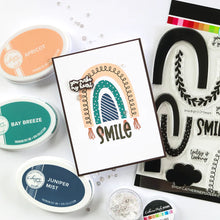 Load image into Gallery viewer, Catherine Pooler - Stamp & Dies Set - Smile Bright. Smile Bright! This 6x8 Stamp Set and coordinating dies are ready for you to piece it together to your hearts content to create a modern, boho rainbow. Available at Embellish Away located in Bowmanville Ontario Canada. Card example by brand ambassador.