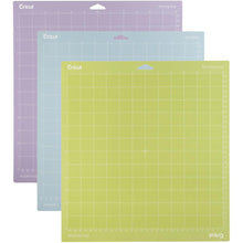 Load image into Gallery viewer, Cricut - Adhesive Back Cutting Mats 12"X12" - 3/Pkg - Green, Blue & Purple. Provo Craft-Cricut Adhesive Back Cutting Mats: Green, Blue And Purple. Each of the three mats has been customized to match the weight of commonly used crafting materials. Each has just the right level of grip to not only hold your material firmly in place during use but also allow you to easily remove the material from the adhesive surface. Available at Embellish Away located in Bowmanville Ontario Canada.