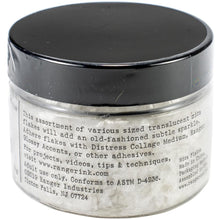 Load image into Gallery viewer, Tim Holtz - Distress Mica Flakes - 50g. This assortment of various sized translucent mica flakes will add an old-fashioned subtle sparkle. Adhere flakes with Distress Collage Medium, Ranger Glossy Accents, or other adhesives (sold separately). This package contains 50g of mica flakes. Conforms to ASTM D 4236. Imported. Available at Embellish Away located in Bowmanville Ontario Canada.