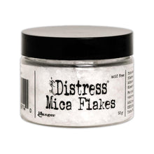 Load image into Gallery viewer, Tim Holtz - Distress Mica Flakes - 50g. This assortment of various sized translucent mica flakes will add an old-fashioned subtle sparkle. Adhere flakes with Distress Collage Medium, Ranger Glossy Accents, or other adhesives (sold separately). This package contains 50g of mica flakes. Conforms to ASTM D 4236. Imported. Available at Embellish Away located in Bowmanville Ontario Canada.