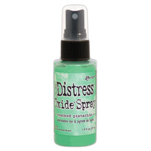 Load image into Gallery viewer, Tim Holtz - Distress Oxide Spray. Creates oxidized effects when sprayed with water. Use for quick and easy ink coverage on porous surfaces. Spray through stencils, layer colors, spritz with water and watch the color mix and blend. Available in a variety of colors, each sold separately. Available at Embellish Away located in Bowmanville Ontario Canada. Cracked Pistachio