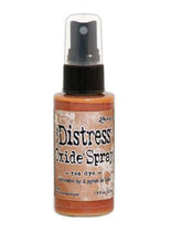 Load image into Gallery viewer, Tim Holtz - Distress Oxide Spray. Creates oxidized effects when sprayed with water. Use for quick and easy ink coverage on porous surfaces. Spray through stencils, layer colors, spritz with water and watch the color mix and blend. Available at Embellish Away located in Bowmanville Ontario Canada. Tea Dye