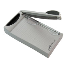 Load image into Gallery viewer, Tim Holtz - Guillotine Mini Trimmer 6.25". The Tim Holtz 6.25 inch / 16cm Mini Trimmer has many features not found in similar products. This product is portable and lightweight. It is perfect for trimming photographs and creating card fronts. Available at Embellish Away located in Bowmanville Ontario Canada.