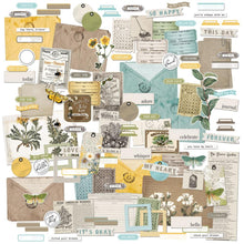 Cargar imagen en el visor de la galería, 49 And Market - Ephemera Bits - Krafty Garden. 114 individual pieces of ephemera in various sizes are included in this pack. This pack is loaded with all sorts of die-cut pieces including frames, tabs, titles, pockets, labels, tags and journaling pieces. Available at Embellish Away located in Bowmanville Ontario Canada
