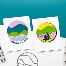 Load image into Gallery viewer, Catherine Pooler - Die - Circle Landscape. Take your scene building up a level with the Circle Landscape Die by adding a backdrop of mountains or water. Or just to add some fun pops of colour. Available at Embellish Away located in Bowmanville Ontario Canada. Example by brand ambassador.
