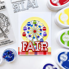 Load image into Gallery viewer, Catherine Pooler - Stamp &amp; Die Set - At the Fair. The icon of the fair coming to town is the Ferris Wheel. The At the Fair Stamp Set and coordinating dies features a Ferris Wheel stamp with a fill in for each car. Available at Embellish Away located in Bowmanville Ontario Canada. Example by brand ambassador.
