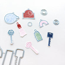 Cargar imagen en el visor de la galería, Catherine Pooler - Stamp &amp; Die Set - Charming Keys. For all of life&#39;s moments where you are moving up or moving out, we have the Charming Keys Stamp Set and Dies! Available at Embellish Away located in Bowmanville Ontario Canada.
