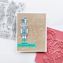 Load image into Gallery viewer, Catherine Pooler - Stamp &amp; Die Set - Nutcracker Sweet. Meet the cutest nutcrackers in town! This whimsical set features charming nutcrackers adorned in a delightful array of sweets and treats, including cupcakes, candy canes, and figgy pudding. Available at Embellish Away located in Bowmanville Ontario Canada. Example by Catherine Pooler Designs.
