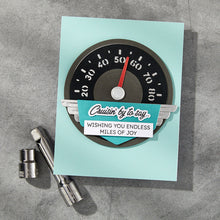 Load image into Gallery viewer, Set of 8 metal dies makes a detailed speedometer with a label design to add phrases for any occasion. Available at Embellish Away in Bowmanville Ontario Canada. Example by brand ambassador.
