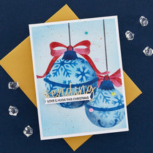 Load image into Gallery viewer, Spellbinders - Stencil By Bibi Cameron Snowflakes - Snowflake Ornaments. Snowflake Ornaments Stencil is part of the Bibi&#39;s Snowflakes Collection by Bibi Cameron and comes in a set of two 6 x 9-inch layering stencils and two masks. Available at Embellish Away located in Bowmanville Ontario Canada. Example by brand ambassador.
