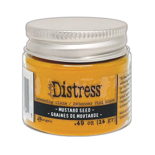 Tim Holtz - Distress Embossing Glaze - Mustard Seed. Add dimension to your projects with new embossing glaze! These translucent embossing powders are ideal for layering on surfaces. Available at Embellish Away located in Bowmanville Ontario Canada.