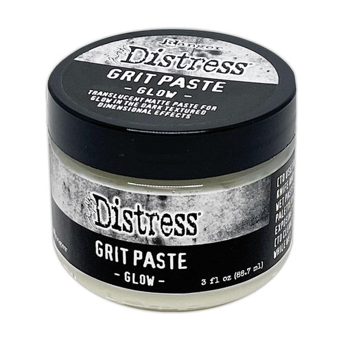 Tim Holtz - Distress Grit Paste - 3oz - Glow. Tim Holtz Distress Mixed Media Medium Grit Paste - Glow is a texture paste that glows in the dark when exposed to the sun or UV light. It adds a glow effect to spooky projects of all kinds. Available at Embellish Away located in Bowmanville Ontario Canada.