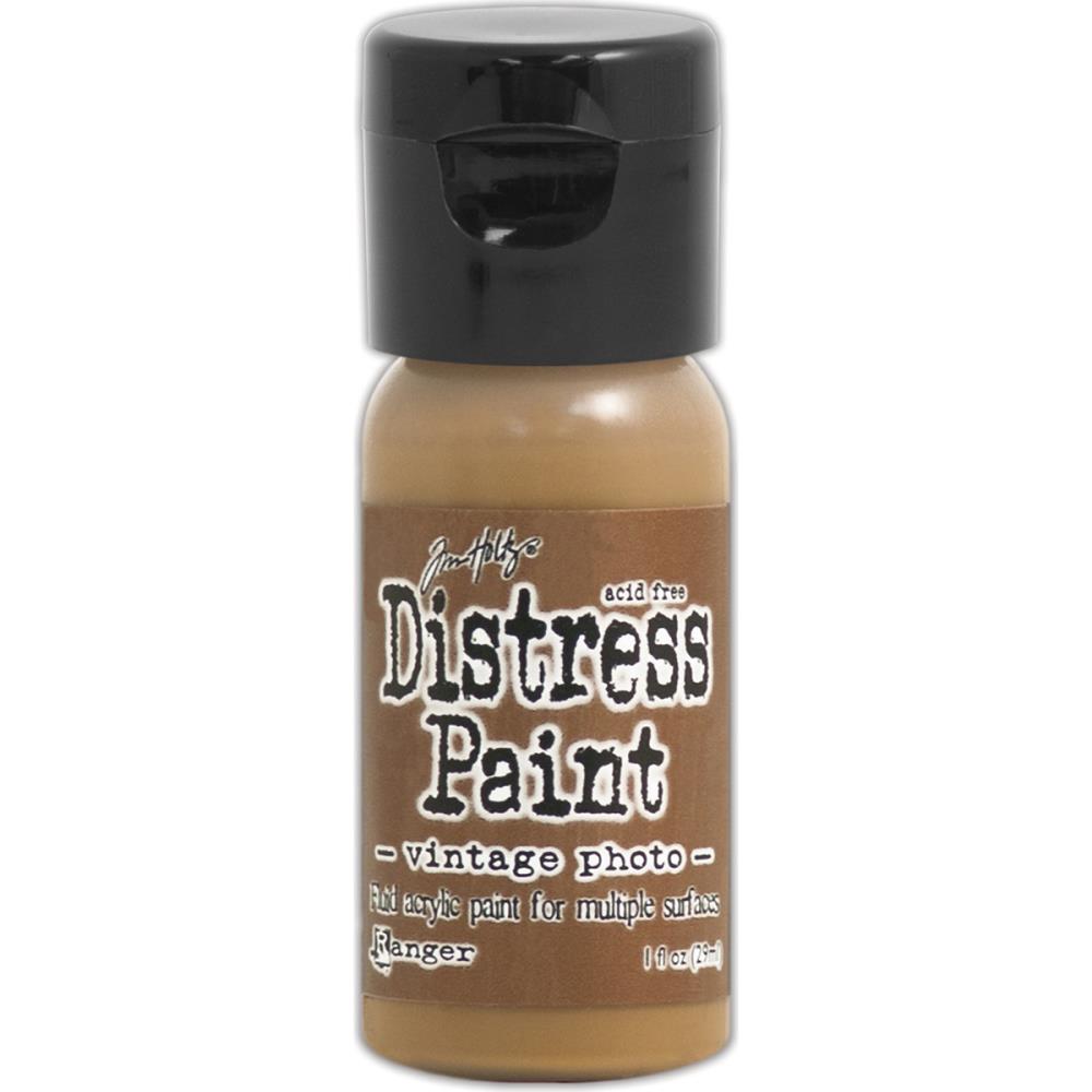 Tim Holtz - Distress Paint Flip Top 1oz - Vintage Photo. This package contains one 1oz bottle of acrylic paint. Comes in a variety of colors. Each sold separately. Made in USA. Available at Embellish Away located in Bowmanville Ontario Canada.