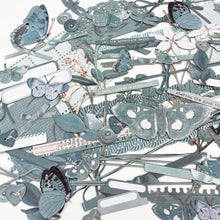 Load image into Gallery viewer, 49 And Market - Laser Cut Outs Elements - Color Swatch - Eucalyptus. 107 elements that include butterflies, florals, photo wraps, bows, buttons, tabs and more! The detailed intricacy of laser cut pieces bring projects to another level with ease. Available at Embellish away located in Bowmanville Ontario Canada.
