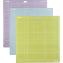 Load image into Gallery viewer, Cricut - Adhesive Back Cutting Mats 12&quot;X12&quot; - 3/Pkg - Green, Blue &amp; Purple. Provo Craft-Cricut Adhesive Back Cutting Mats: Green, Blue And Purple. Each of the three mats has been customized to match the weight of commonly used crafting materials. Each has just the right level of grip to not only hold your material firmly in place during use but also allow you to easily remove the material from the adhesive surface. Available at Embellish Away located in Bowmanville Ontario Canada.
