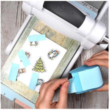 Load image into Gallery viewer, Heffy Doodle - Memo Tape - Refill. Refill roll of Heffy Memo Tape for the Heffy Memo Tape Dispenser HFD0066. This low tack tape is perfect for masking areas on your projects or on stencils, or for temporarily holding down dies or die cut elements. Use with your dies to create perfect masks or with punches to create temporary stencils. Available at Embellish Away located in Bowmanville Ontario Canada. use example.
