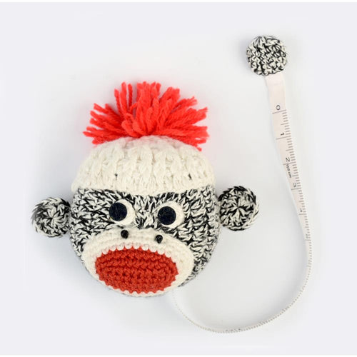 Lantern Moon - Tape Measure - Sock Monkey - This hand crocheted sock monkey tape measure is sure to make you smile. Metric and English measurements are shown on opposite sides. This package contains one 5-foot long retractable tape measure. Imported. Available at Embellish Away located in Bowmanville Ontario Canada.
