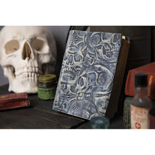 Load image into Gallery viewer, Sizzix - 3D Texture Fades Embossing Folder By Tim Holtz - Skulls. Use the embossing folders to turn ordinary cardstock, paper, metallic foil or vellum into an embossed, textured masterpiece. Available at Embellish Away located in Bowmanville Ontario Canada Book cover example by brand ambassador.
