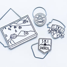 Load image into Gallery viewer, Catherine Pooler - Stamp &amp; Dies - Ski Lodge. The Ski Lodge Stamp Set gives you a view of the mountain along with badges and sentiments for adorable snowy card making! You can also add Alpine View Die for your wintery mix (Sold Separately). Available at Embellish Away located in Bowmanville Ontario Canada.

