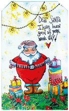 Load image into Gallery viewer, Studio Light - ABM Clear Stamp - Christmas Dear Santa - Essentials - 148x210x1mm - 1 PC - nr.84. This clear stamp set features Santa Claus, presents, a snowflake and garland. 6 stamps. Size: 5.8x8.3 in. Available at Embellish Away located in Bowmanville Ontario Canada. tag example by brand ambassador.
