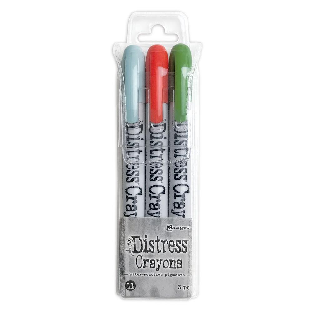 Tim Holtz - Distress Crayon Set - Set #11. Tim Holtz Distress Crayons are formulated to achieve vibrant coloring effects on porous surfaces for mixed-media. The smooth water-reactive pigments are ideal for creating brilliant backgrounds, watercoloring and more. This package contains three 5.25 inch long crayons in Speckled Egg, Crackling Campfire and Rustic Wilderness Distress. Available at Embellish Away located in Bowmanville Ontario Canada.