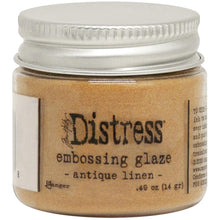 Load image into Gallery viewer, Tim Holtz - Distress Embossing Glaze - Antique Linen. Add dimension to your projects with new embossing glaze! These translucent embossing powders are ideal for layering on surfaces. This package contains .49oz of embossing glaze. Available at Embellish Away located in Bowmanville Ontario Canada.
