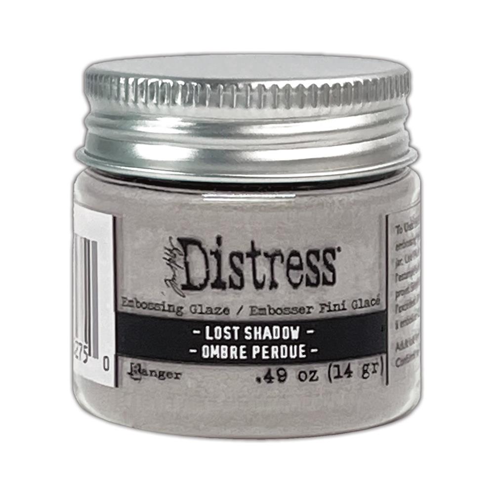 Tim Holtz - Distress Embossing Glaze - Lost Shadow. Add dimension to your projects with new embossing glaze! These translucent embossing powders are ideal for layering on surfaces. This package contains .49oz of embossing glaze. Available at Embellish Away located in Bowmanville Ontario Canada.