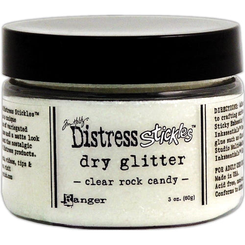 Tim Holtz - Distress Stickles Dry Glitter - 3oz - Clear Rock Candy. Add this loose glitter to your paper crafting and mixed media projects to add a touch of shimmer and shine. It features a unique combination of variegated glitter sizes and a matte look to compliment the nostalgic palette of Distress products. Each package contains one 3oz jar of glitter. Color: Clear Rock Candy. Acid free, non-toxic. Made in USA. Available at Embellish Away located in Bowmanville Ontario Canada.