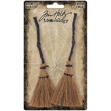 Load image into Gallery viewer, Tim Holtz - Idea-Ology - Broomsticks - 2/Pkg. With Tim Holtz Broomsticks, your spooky Halloween scene can take flight. These detailed broomsticks feature a crooked wooden broom handle and stitched brush. 2 pieces Elements measure: 1.5 x 5.0 inches. Available at Embellish Away located in Bowmanville Ontario Canada.
