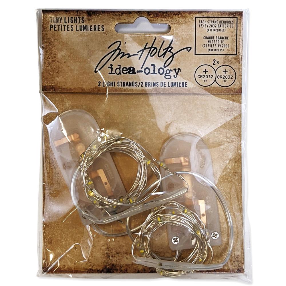 Tim Holtz - Idea-Ology Battery - Operated Wire Light Strands - 2/Pkg - Tiny Lights - Clear (No Batteries). While you need the perfect paper to start your project, you also need the perfect embellishment! Requires two 3V 2032 batteries, not included. Available at Embellish Away located in Bowmanville Ontario Canada.