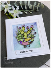 Charger l&#39;image dans la galerie, Woodware - 4&quot;x4&quot; Clear Singles Stamp - Succulent Display. On trend stamp with a pot filled with succulents the pot is calling out to be coloured in hot desert colours. Add a personal touch with your favourite colouring medium and the fun words. Designed by Francoise Read. These stamps would be perfect for cards and scrapbook pages as well as mixed media or fun décor projects. Available at Embellish Away located in Bowmanville Ontario Canada. Card design by Debbie Smith
